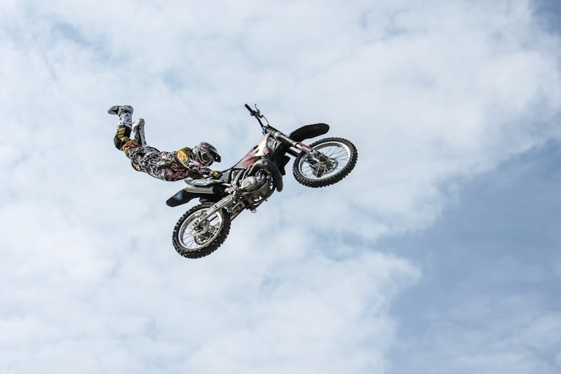 Freestyle motocross rider performing a Superman air